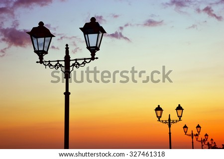 Silhouettes of lanterns at sunset