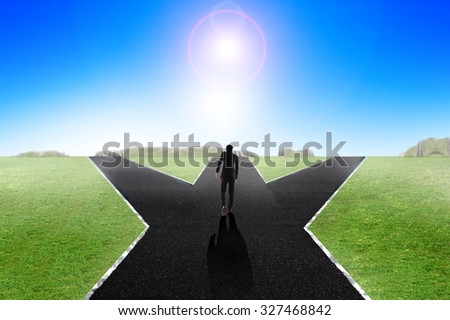 Business man walking down middle of the road,decision making