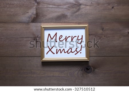 One Golden Picture Frame On Wooden Background. English Text Merry Xmas. Rutic Vintage Or Retro Style. Background With Copy Space As Greeting Card