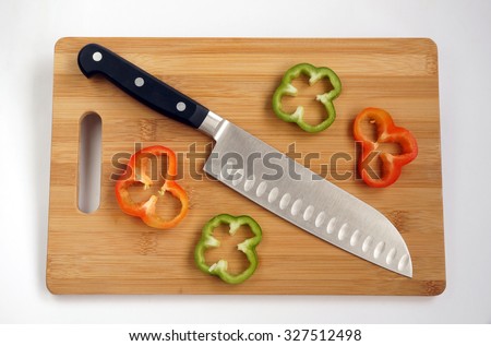 Knife cook universal with a blade like Santoku on a chopping board Royalty-Free Stock Photo #327512498