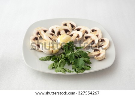 plate of raw mushrooms with garlic and parsley