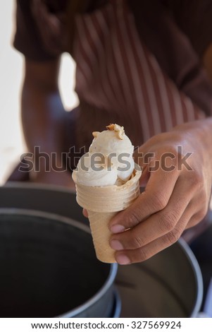 man holding ice cream cone 