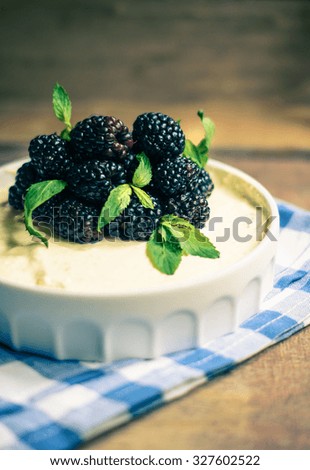 Cheesecake with blackberries and mint, selected focus. Toned picture