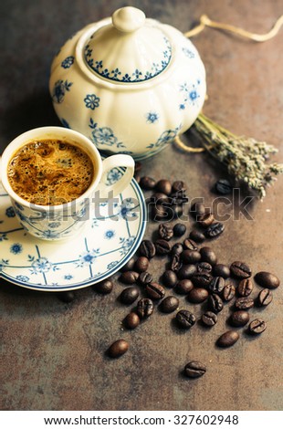 Vintage cup with black coffee, dry lavender flowers and coffee beans. Toned picture