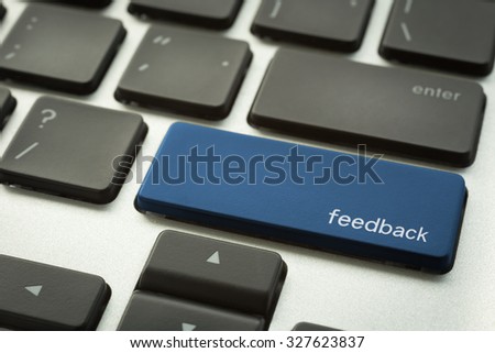 Close up computer keyboard focus on a blue button with typographic word FEEDBACK. Support and service concepts.