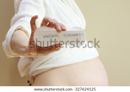 Vaginal discharge written on a pantyliner kept by pregnant woman 
