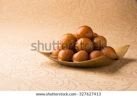 indian sweet gulab jamun in square shape brass plate, closeup view Royalty-Free Stock Photo #327627413