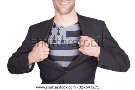 Businessman opening suit to reveal shirt with flag, Brittany