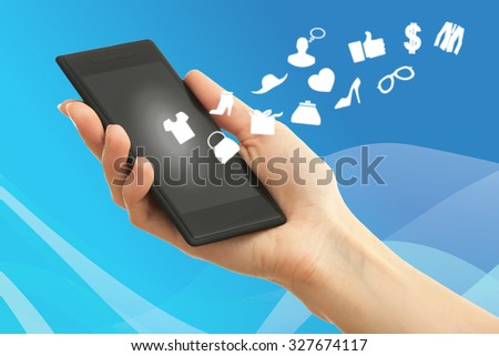 Hand holding smartphone with market icons