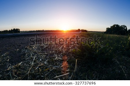 Autumn landscape in the village on road in sunset time