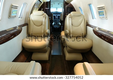 Front part of cabin of business jet - seats with lowered armrests