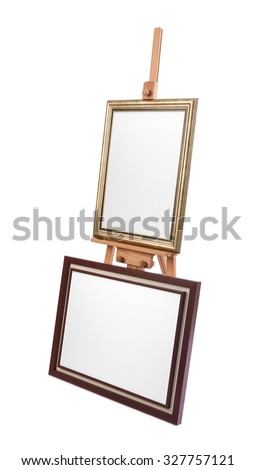 Two white painter canvas in frame on wooden easel isolated on white