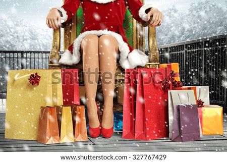 Snow Queen on armchair and few bags of gifts 