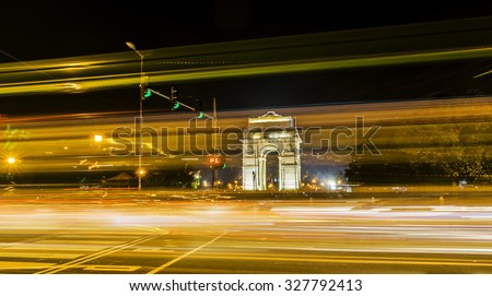 A wide angle long exposure shot of India Gate (formerly known as the All India War Memorial) with light trails of moving vehicles at Rajpath, New Delhi, India. Royalty-Free Stock Photo #327792413
