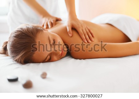 Spa woman. Female enjoying relaxing back massage in cosmetology spa centre. Body care, skin care, wellness, wellbeing, beauty treatment concept. Royalty-Free Stock Photo #327800027