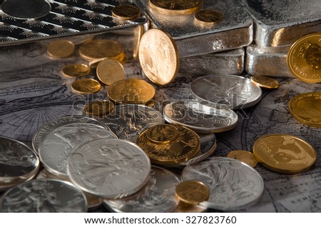 Gold & Silver Coins with Silver Bars on map Royalty-Free Stock Photo #327823760