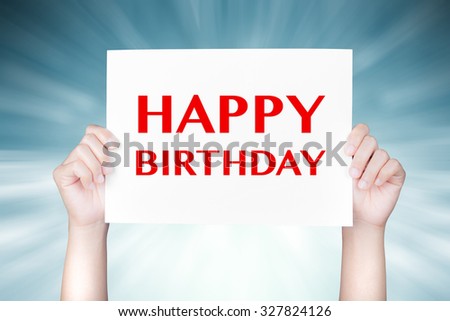 hand holding happy birthday sign on blue abstract background 