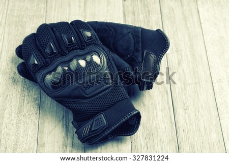 Motorcycle gloves on wooden ,diet concept-vintage effect.