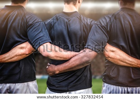 Rugby fans in arena against rugby players standing together before match Royalty-Free Stock Photo #327832454
