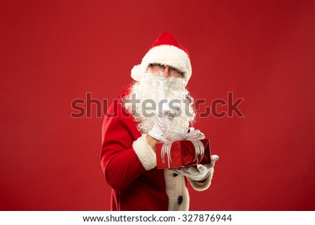 Santa Claus on a red background with gifts