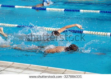 Heat of children on one path in the swimming pool Royalty-Free Stock Photo #327886331