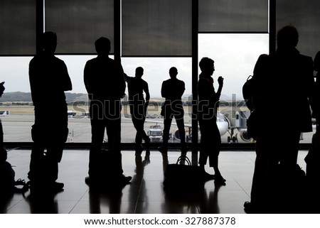silhouettes of passengers in an airport Royalty-Free Stock Photo #327887378