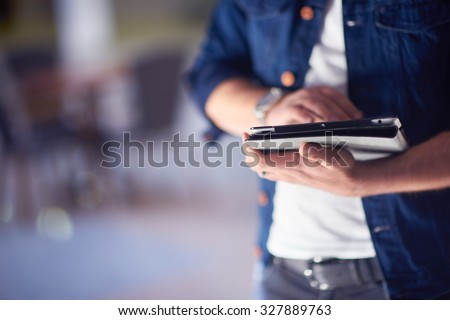 student using tablet computer for education in school, university interior in background Royalty-Free Stock Photo #327889763