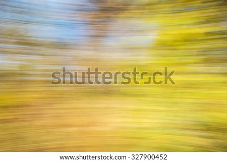 motion blur abstract of golden fall foliage ans sky
