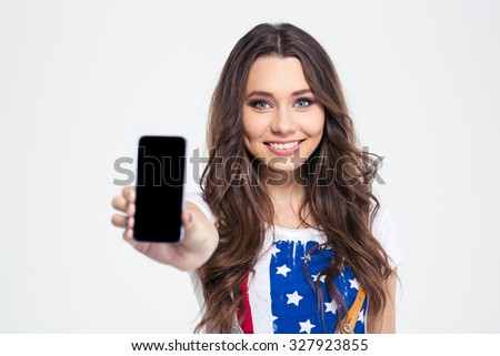 Portrait of a smiling woman showing blank smartphone screen isolated on a white background