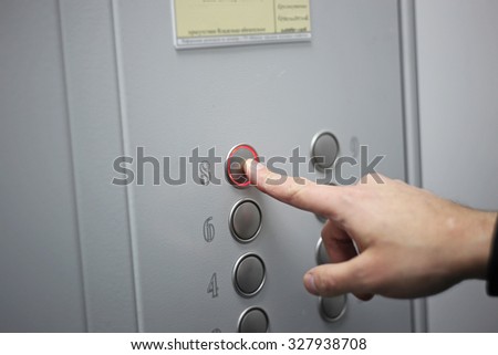 Male hand pressing on the elevator button