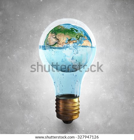 Glass light bulb and Earth planet inside. Elements of this image are furnished by NASA 