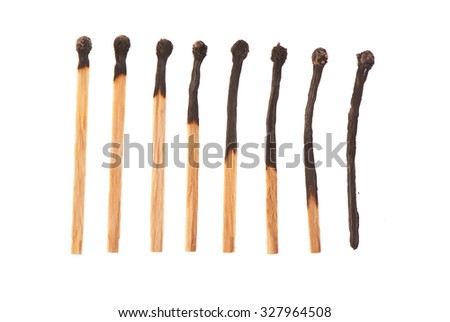 Set of eight burnt wooden matches arranged in ascending order isolated on white background Royalty-Free Stock Photo #327964508