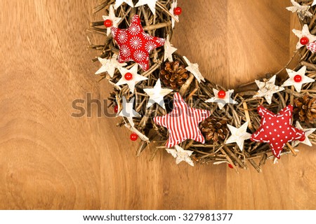 Christmas handmade wreath decoration Shabby Chic white wooden stars with red gingham fabric pattern over wooden background - retro style design, copy space