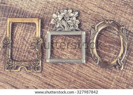 Vintage frames on a wooden background. Cross processed image