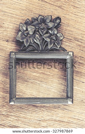 Vintage frame on a wooden background. Cross processed image