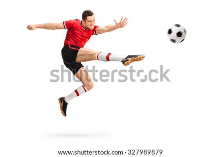Studio shot of a male football professional kicking a ball in mid-air isolated on white background