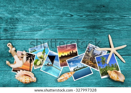 travel photos and seashells on azure wood background