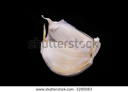 2 Clove of Garlic peeled open over black background