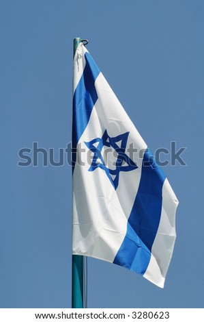 The Israeli flag on a background of the sky. A weak wind.