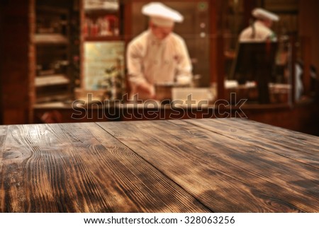 dark interior of restaurant with kitchen chef and board of wood 