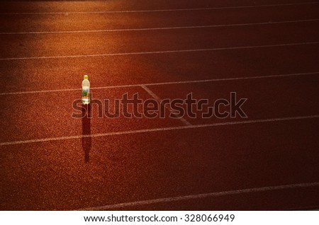 Bottle on athletics track before morning run