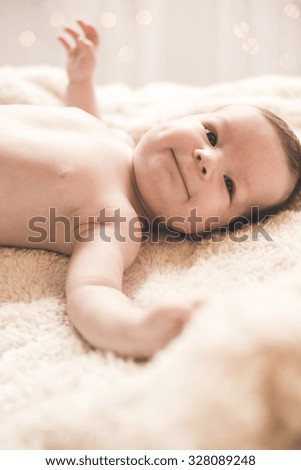 Picture of content baby lying with arms open