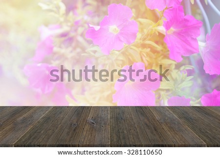 Wood terrace and Beautiful Plumeria flowers soft focus and bright light tone filtered background