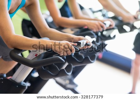 Fit people in a spin class at the gym Royalty-Free Stock Photo #328177379