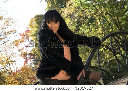 young happy woman in autumn park