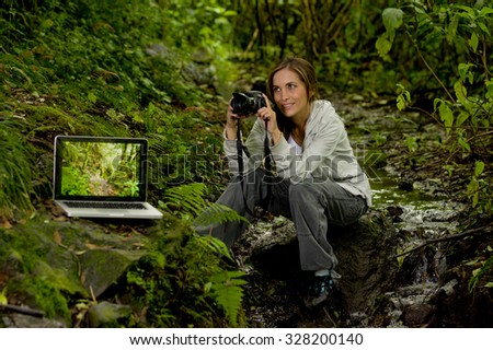 Beautiful young happy female photographer explorer in the jungle