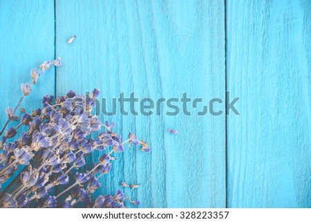 Dried lavender on wooden painted blue background. Retro toned image. Royalty-Free Stock Photo #328223357