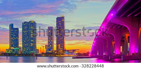 Miami Florida at sunset, colorful skyline of illuminated buildings and Macarthur causeway bridge