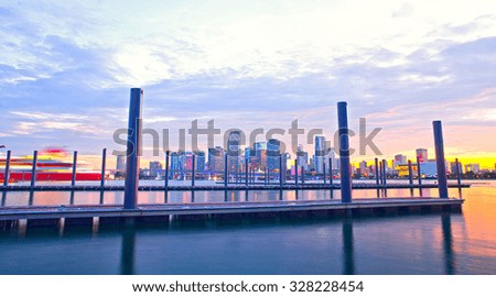 Miami Florida at sunset, colorful skyline of illuminated buildings and docks