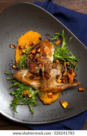 Roasted quail with pumpkin puree and salad